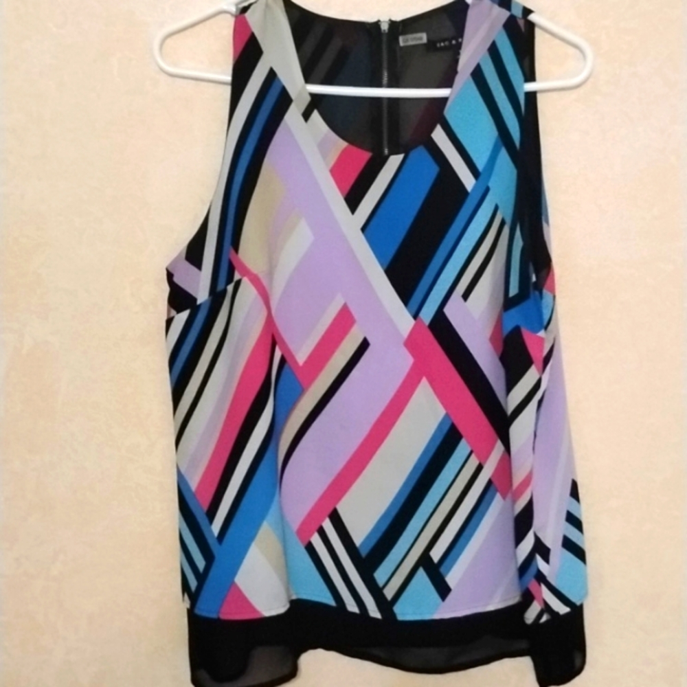 Light chiffon layered sleeveless blouse with back zipper and black sheer lining.